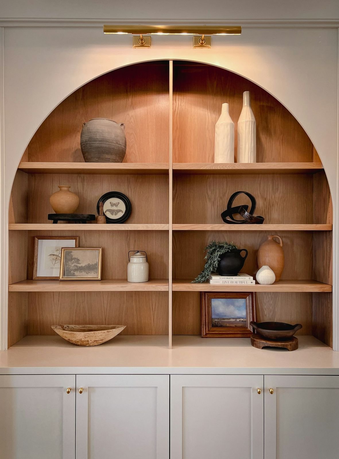 Arched built-in shelving and cabinetry